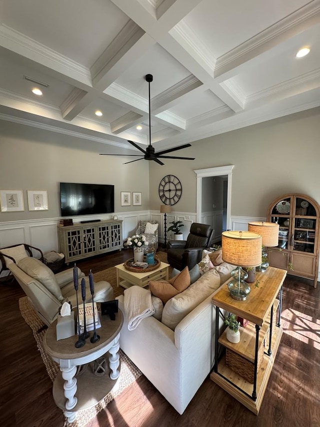 living room with beam ceiling, a ceiling fan, a wainscoted wall, and coffered ceiling