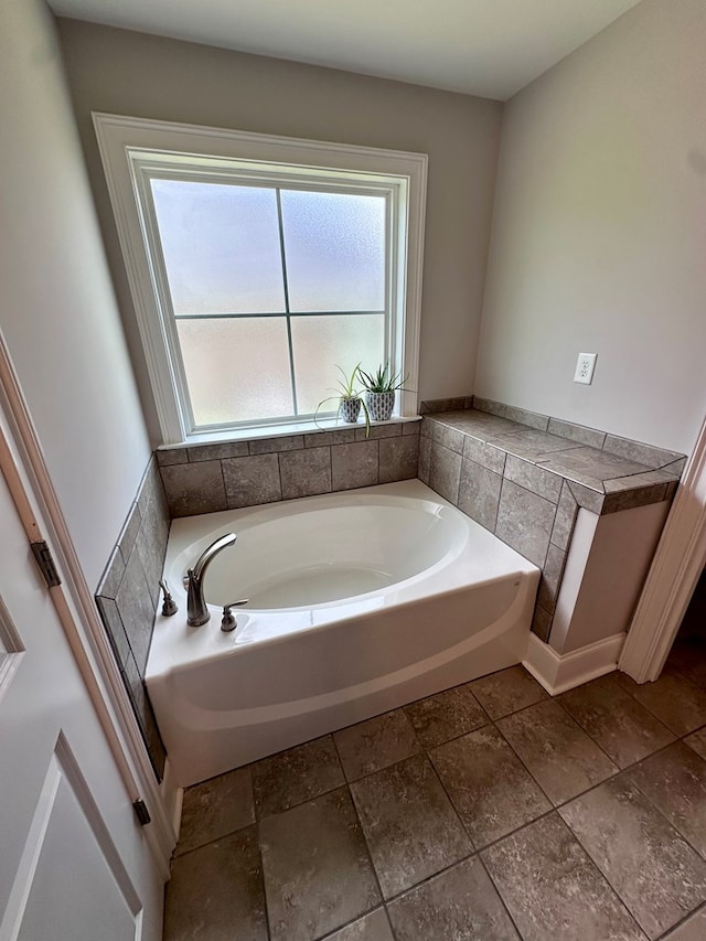 bathroom featuring a garden tub and a wealth of natural light