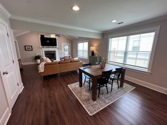 dining space with baseboards, dark wood finished floors, and a fireplace
