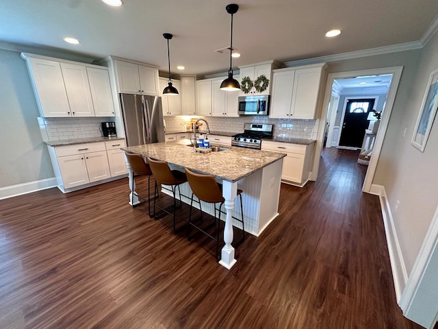 kitchen with a sink, appliances with stainless steel finishes, and white cabinets