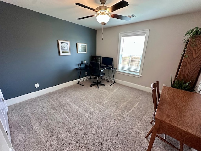 carpeted office space featuring a ceiling fan, baseboards, and visible vents