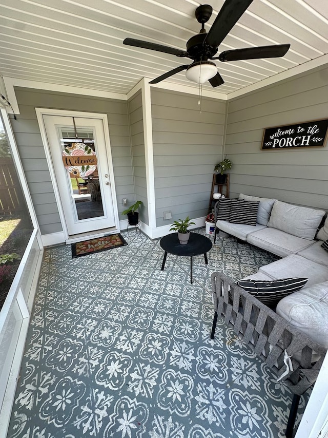 sunroom / solarium featuring an outdoor living space and ceiling fan