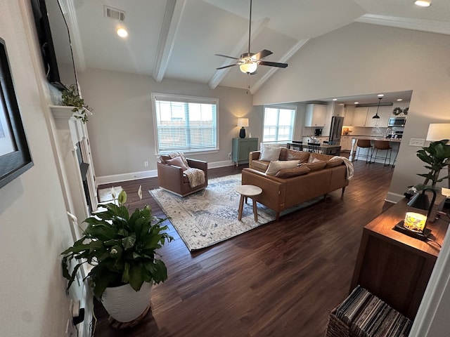 living area with ceiling fan, visible vents, a fireplace, vaulted ceiling, and dark wood finished floors