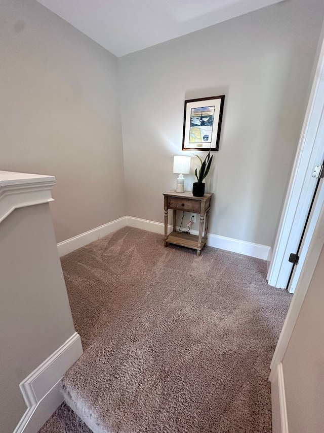 staircase with carpet floors and baseboards