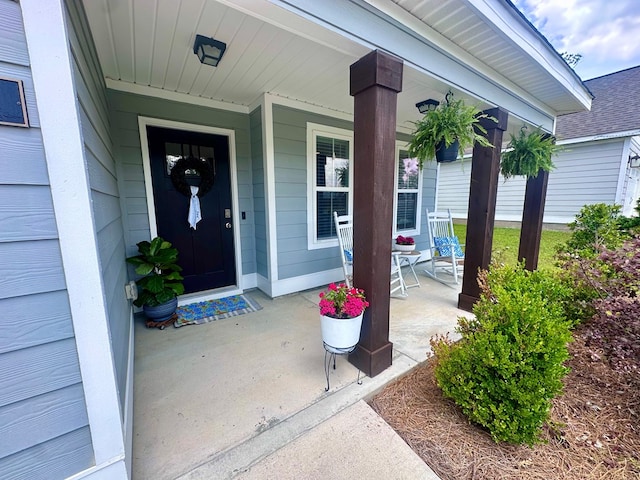 view of exterior entry with a porch