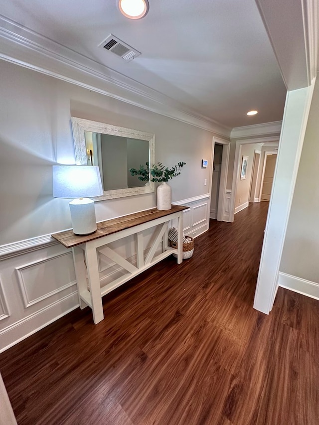 hallway with crown molding, a wainscoted wall, recessed lighting, and visible vents