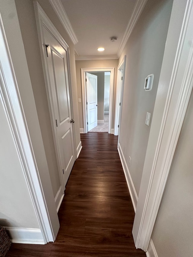 hall with crown molding, recessed lighting, dark wood-style flooring, and baseboards