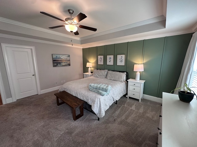 bedroom with crown molding, dark carpet, and a tray ceiling