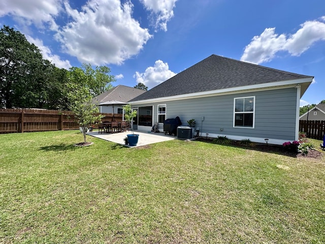 back of property featuring a lawn, central air condition unit, fence, a patio, and a shingled roof
