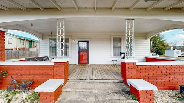 view of exterior entry featuring a porch