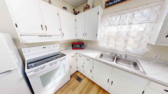 kitchen with sink, tasteful backsplash, light wood-type flooring, white appliances, and white cabinets