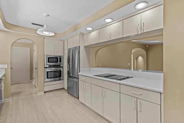 122 Greenview Cir, Dothan, AL 36301 - kitchen with appliances with stainless steel finishes, light countertops, arched walkways, and light wood finished floors