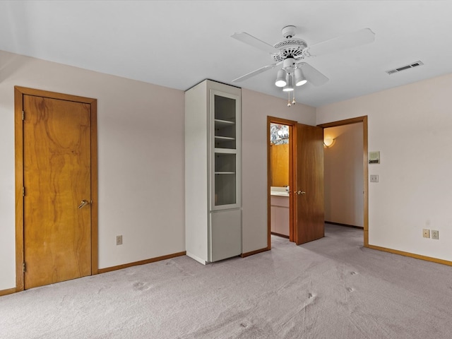 unfurnished bedroom featuring ceiling fan and light colored carpet