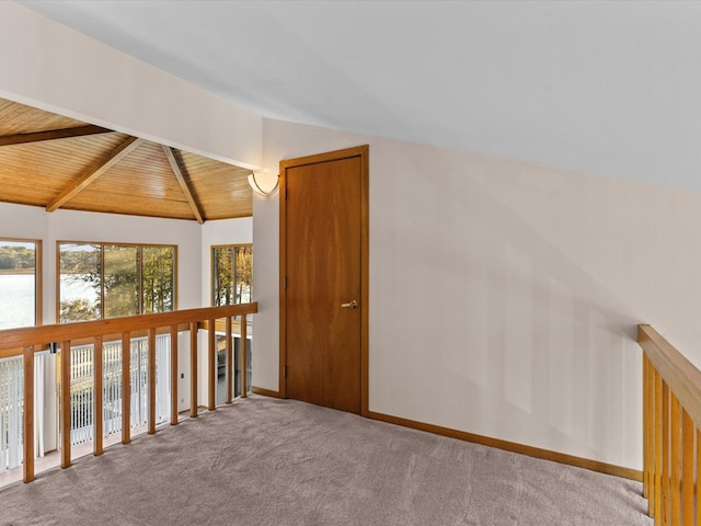 bonus room with lofted ceiling with beams, light colored carpet, and wooden ceiling