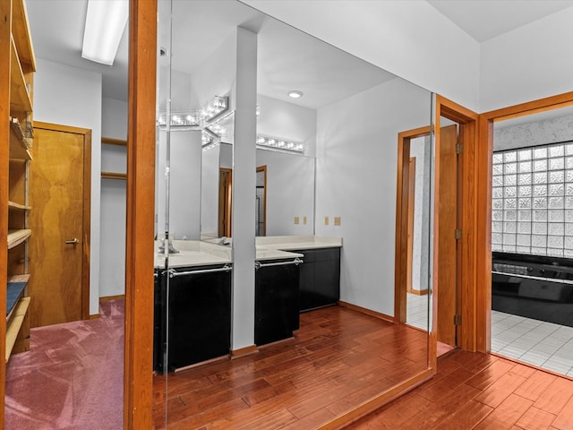 bathroom featuring hardwood / wood-style flooring and vanity