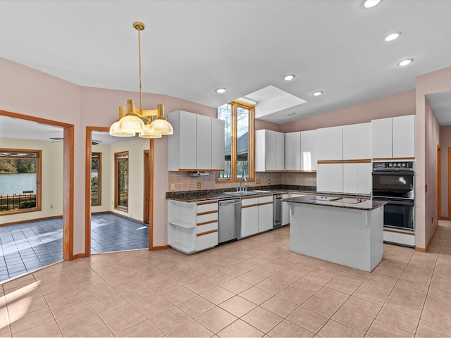 kitchen with tasteful backsplash, a center island, hanging light fixtures, dishwasher, and white cabinets