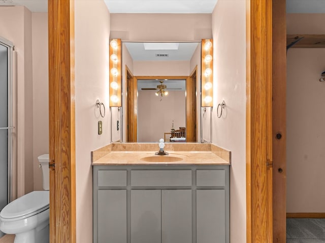 bathroom featuring vanity, ceiling fan, and toilet