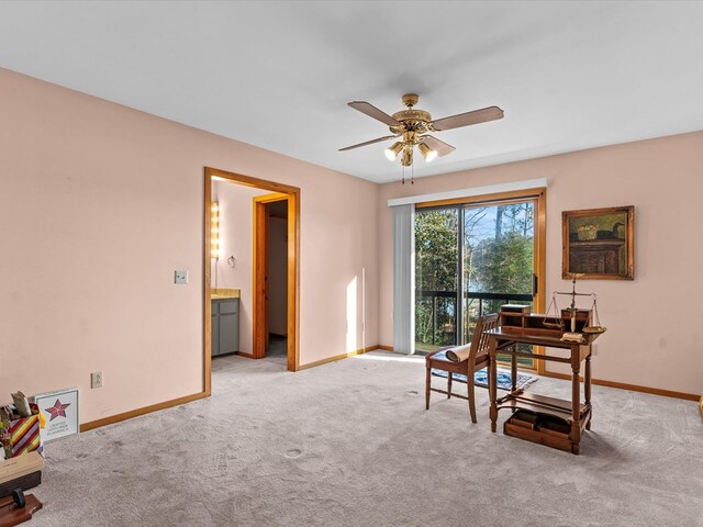 carpeted office featuring ceiling fan