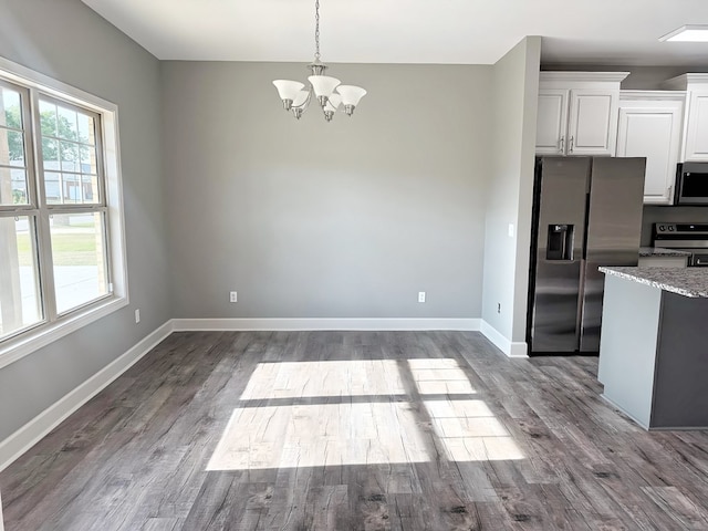 227 Tiffany Dr, Dothan, AL 36301 - kitchen with white cabinets, an inviting chandelier, dark wood finished floors, stainless steel appliances, and baseboards