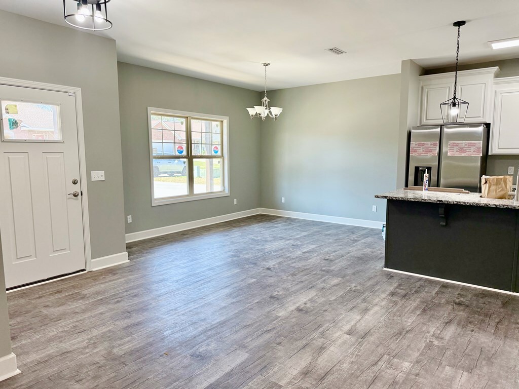 kitchen featuring stone countertops, a kitchen breakfast bar, sink, and a large island with sink