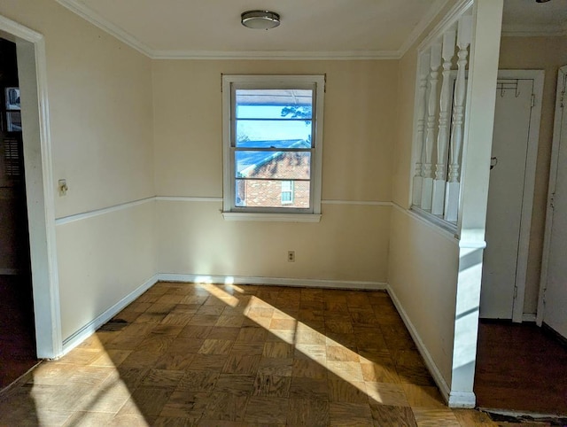 spare room featuring parquet flooring and crown molding