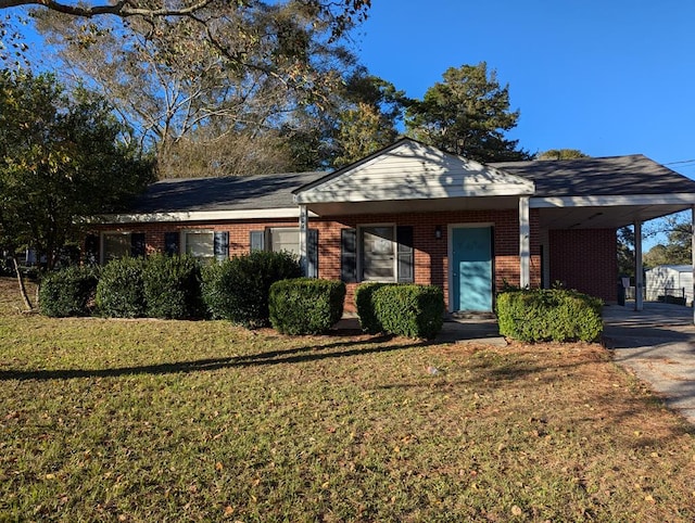 ranch-style house featuring a front yard and a carport