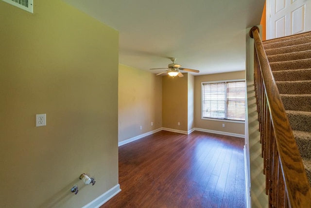 104 Ashwood Dr, Dothan, AL 36303 - spare room featuring dark wood-type flooring, a ceiling fan, and stairway