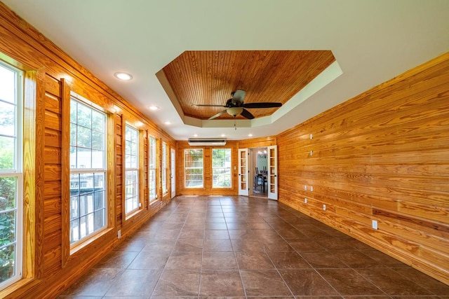 104 Ashwood Dr, Dothan, AL 36303 - spare room with a tray ceiling, wood walls, ceiling fan, healthy amount of natural light, and wood ceiling