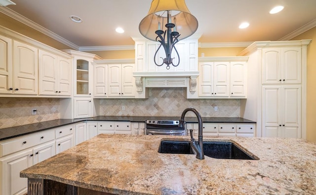 104 Ashwood Dr, Dothan, AL 36303 - kitchen with dark stone counters, ornamental molding, backsplash, stainless steel range, and recessed lighting