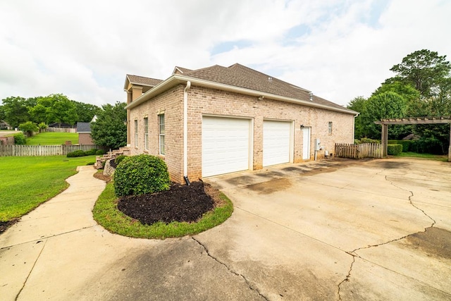 104 Ashwood Dr, Dothan, AL 36303 - view of side of home featuring brick siding, concrete driveway, a pergola, an attached garage, and roof with shingles
