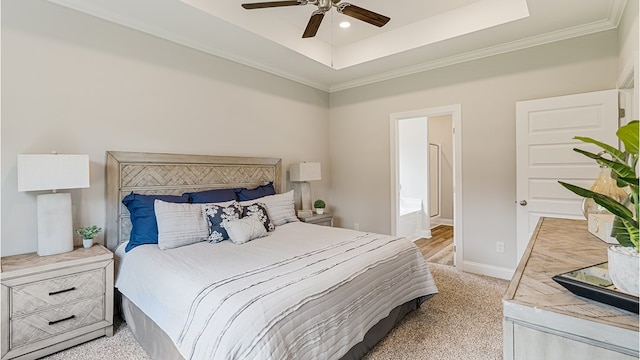 bedroom with crown molding, a raised ceiling, light colored carpet, ceiling fan, and baseboards