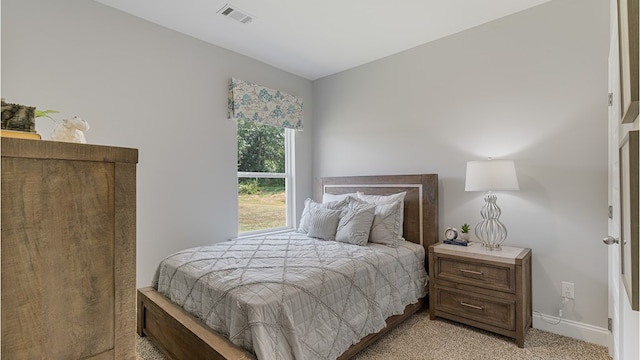 bedroom featuring visible vents and baseboards