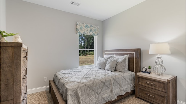 bedroom with visible vents and baseboards