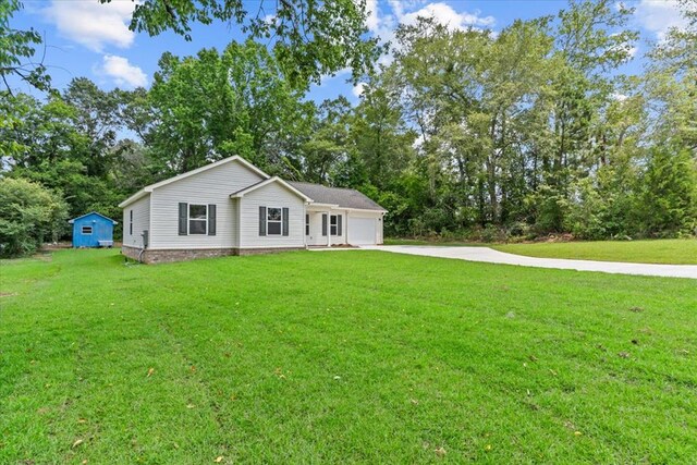 1182 N N Park Ave, Dothan, AL 36303 - view of front of property with concrete driveway, a garage, a front yard, and view of scattered trees