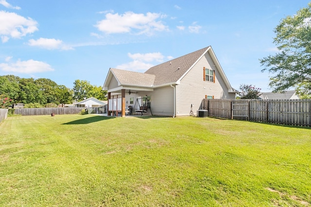 back of house featuring a lawn, ceiling fan, central AC unit, and a patio area