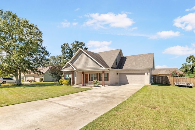 view of front facade with a front yard, a garage, and covered porch