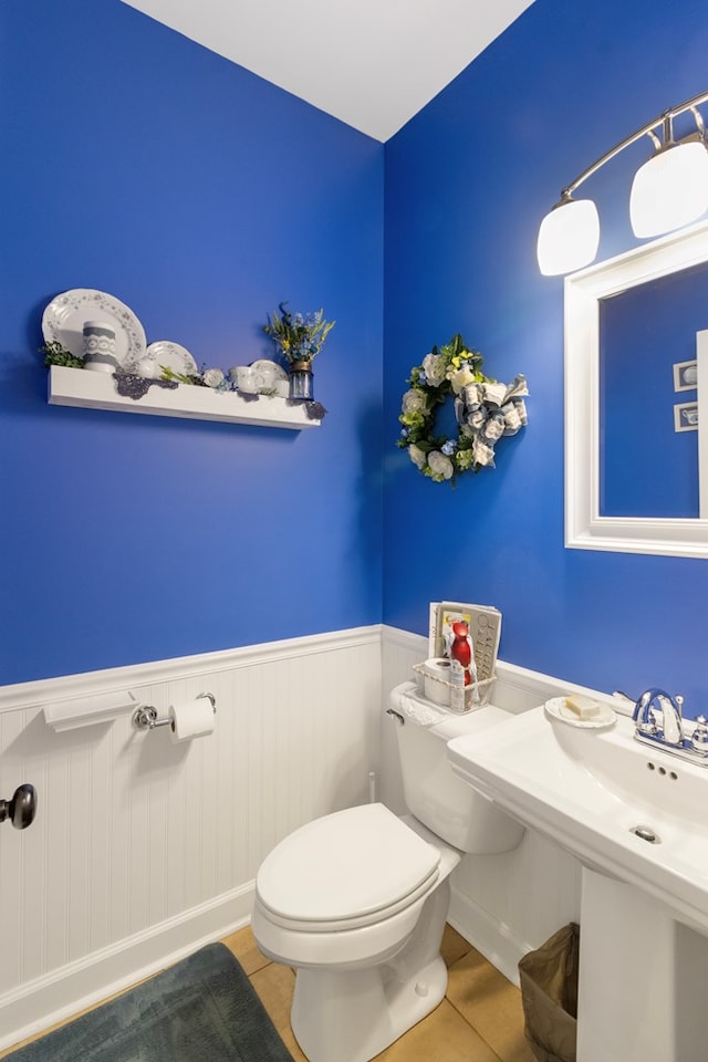 bathroom with sink, tile patterned flooring, and toilet