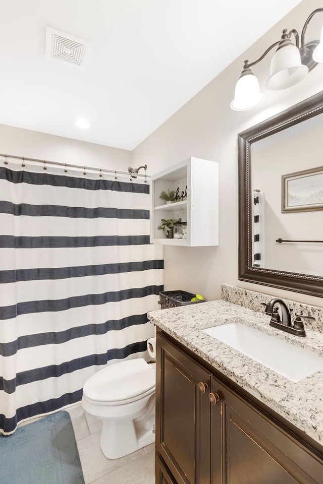 bathroom with tile patterned floors, a shower with curtain, vanity, and toilet