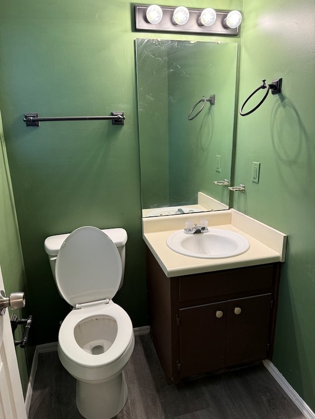 1208 E Newton St, Dothan, AL 36303 - half bath with wood finished floors, toilet, baseboards, and vanity