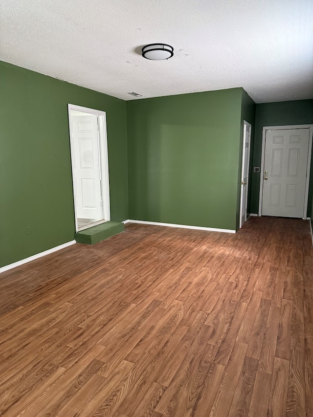 1208 E Newton St, Dothan, AL 36303 - spare room with wood finished floors, baseboards, and a textured ceiling