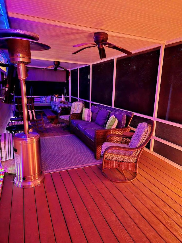 wooden deck with an outdoor hangout area and ceiling fan