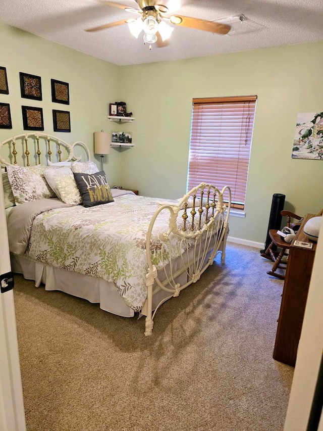 bedroom with carpet flooring, ceiling fan, and a textured ceiling