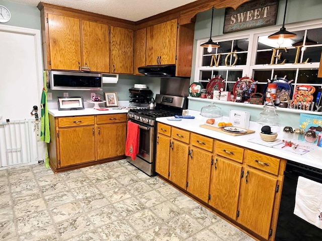 kitchen featuring a textured ceiling, hanging light fixtures, stainless steel appliances, and range hood