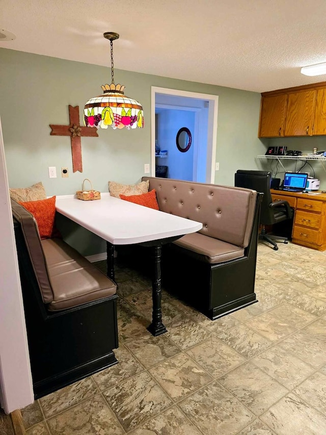 dining space featuring a textured ceiling