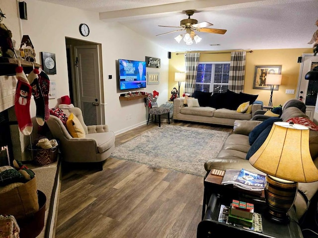 living room with vaulted ceiling with beams, ceiling fan, dark hardwood / wood-style flooring, and a textured ceiling