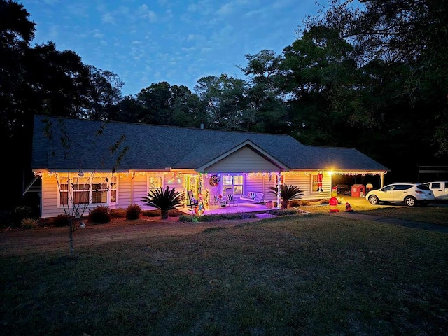 view of front of property with a lawn and a carport