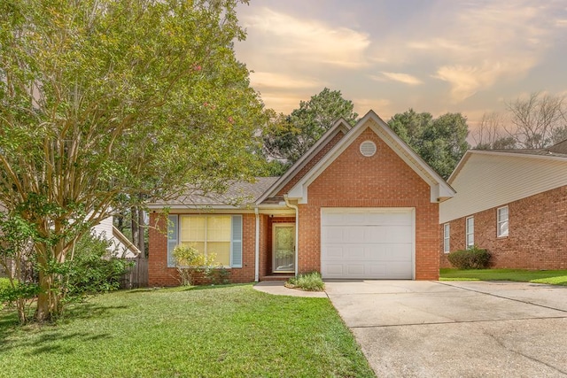 706 W Roxbury Rd, Dothan, AL 36305 - view of front of home featuring concrete driveway, a garage, a lawn, and brick siding