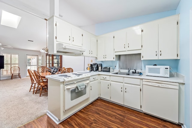 706 W Roxbury Rd, Dothan, AL 36305 - kitchen with white appliances, under cabinet range hood, a skylight, and white cabinetry