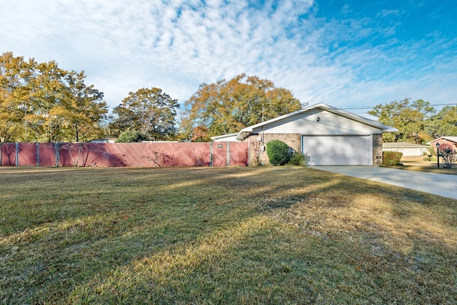 exterior space featuring fence, driveway, and an attached garage