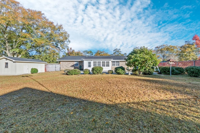 back of house featuring an outbuilding and a yard